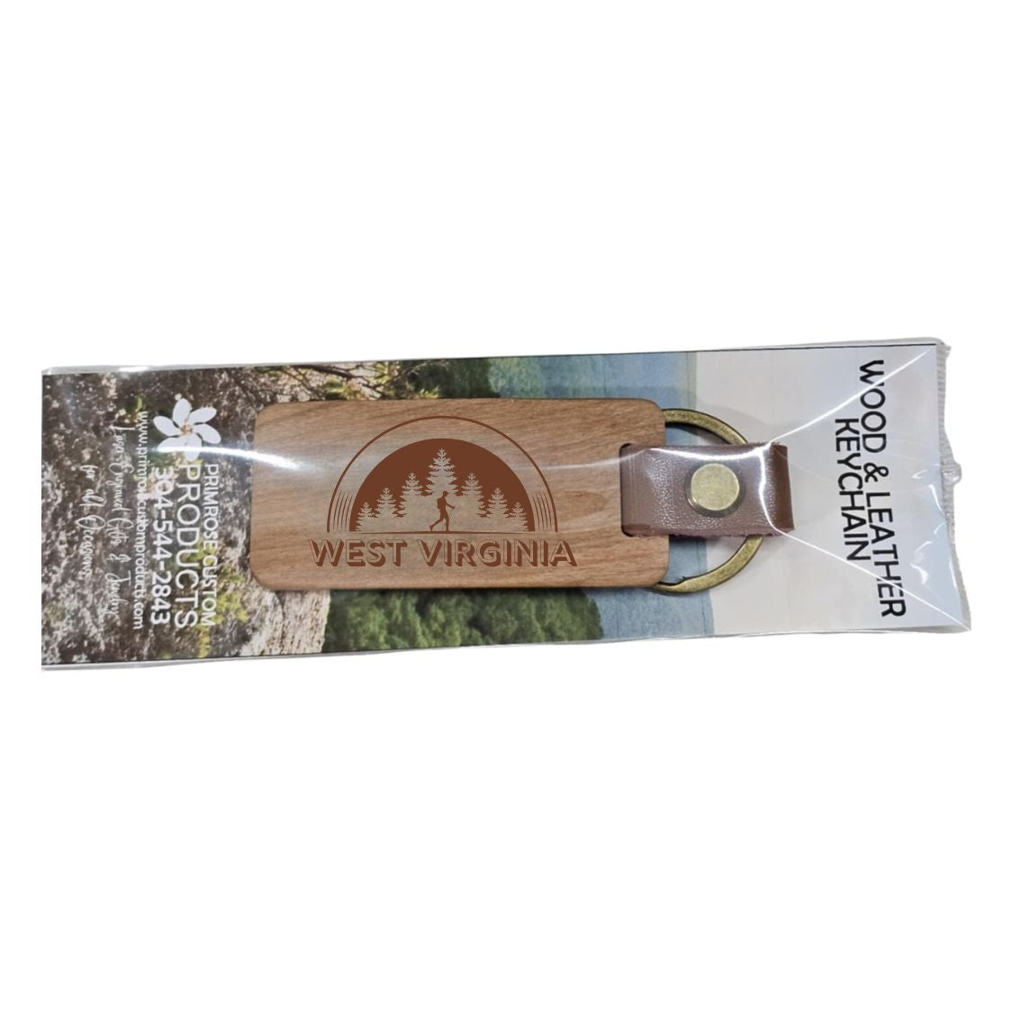 Laser engraved wooden keychain with a leather bound keyring designed with the image of an arch with pine trees and a hiker underneath and the words West Virginia along the bottom.